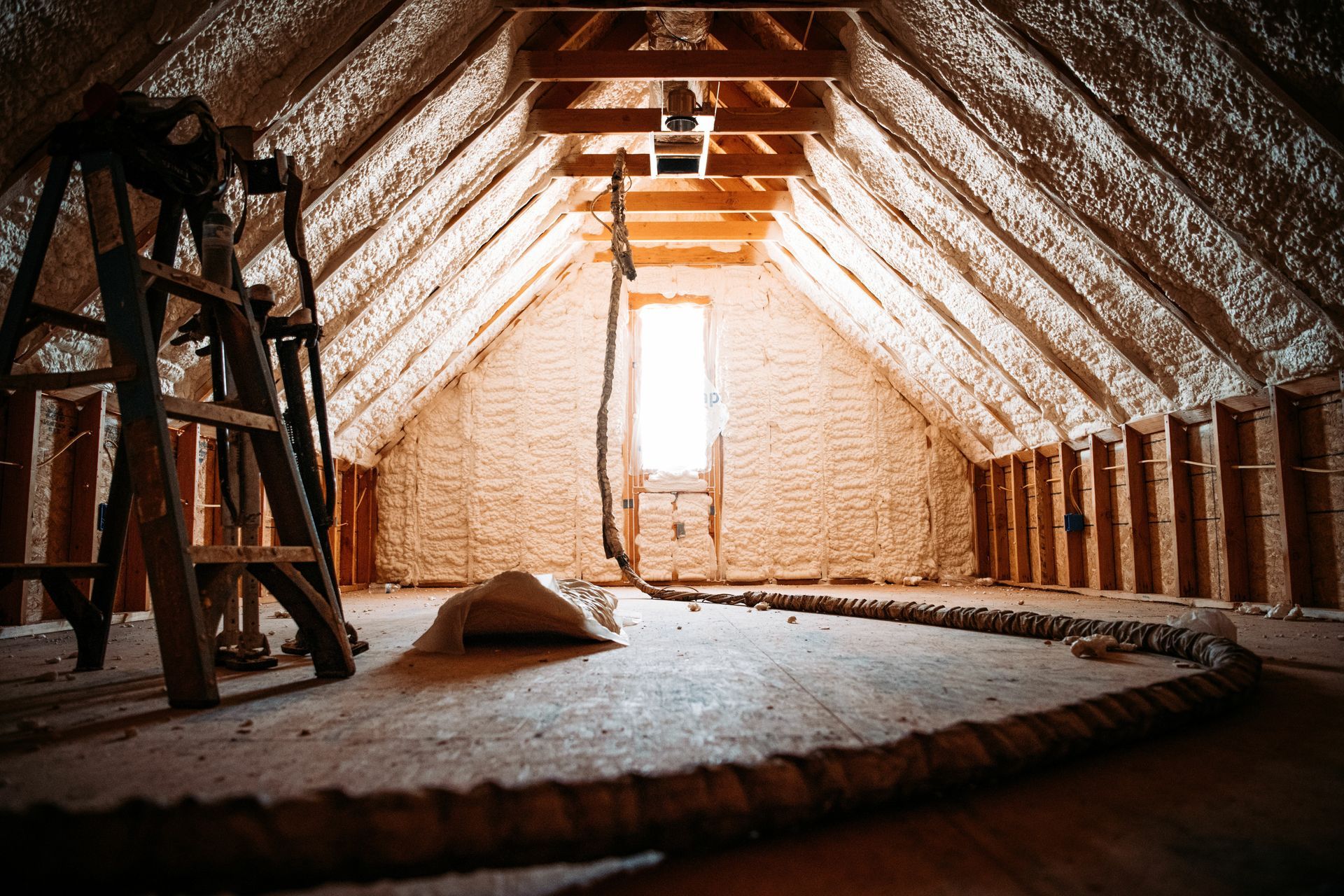 A ladder is sitting in the attic of a house under construction.