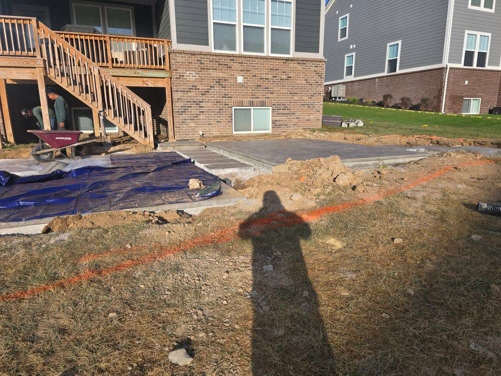 Backyard patio construction, dirt and gravel surrounding a concrete slab. Orange string line.