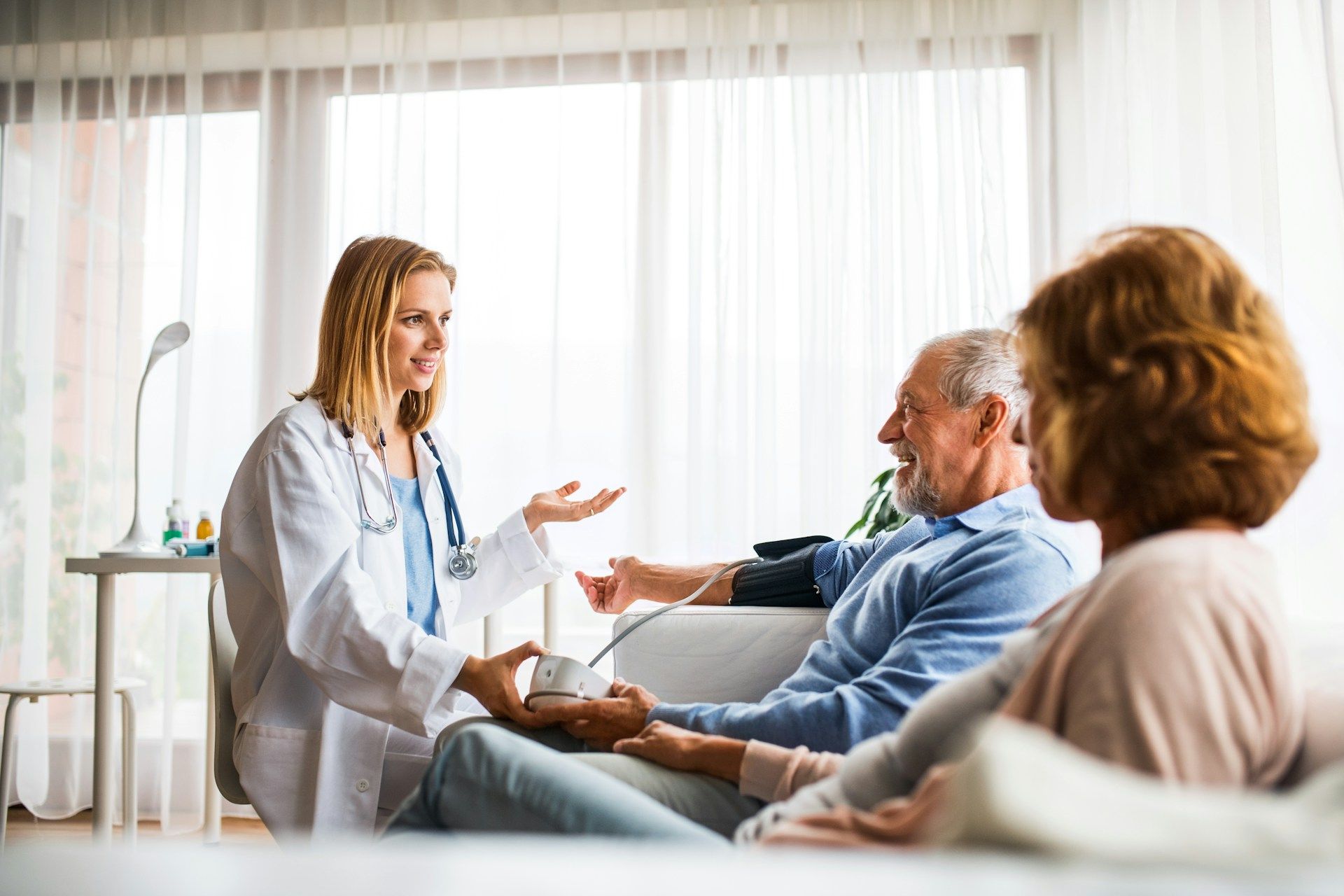 Family smiles inside a car, driving on a sunny day.