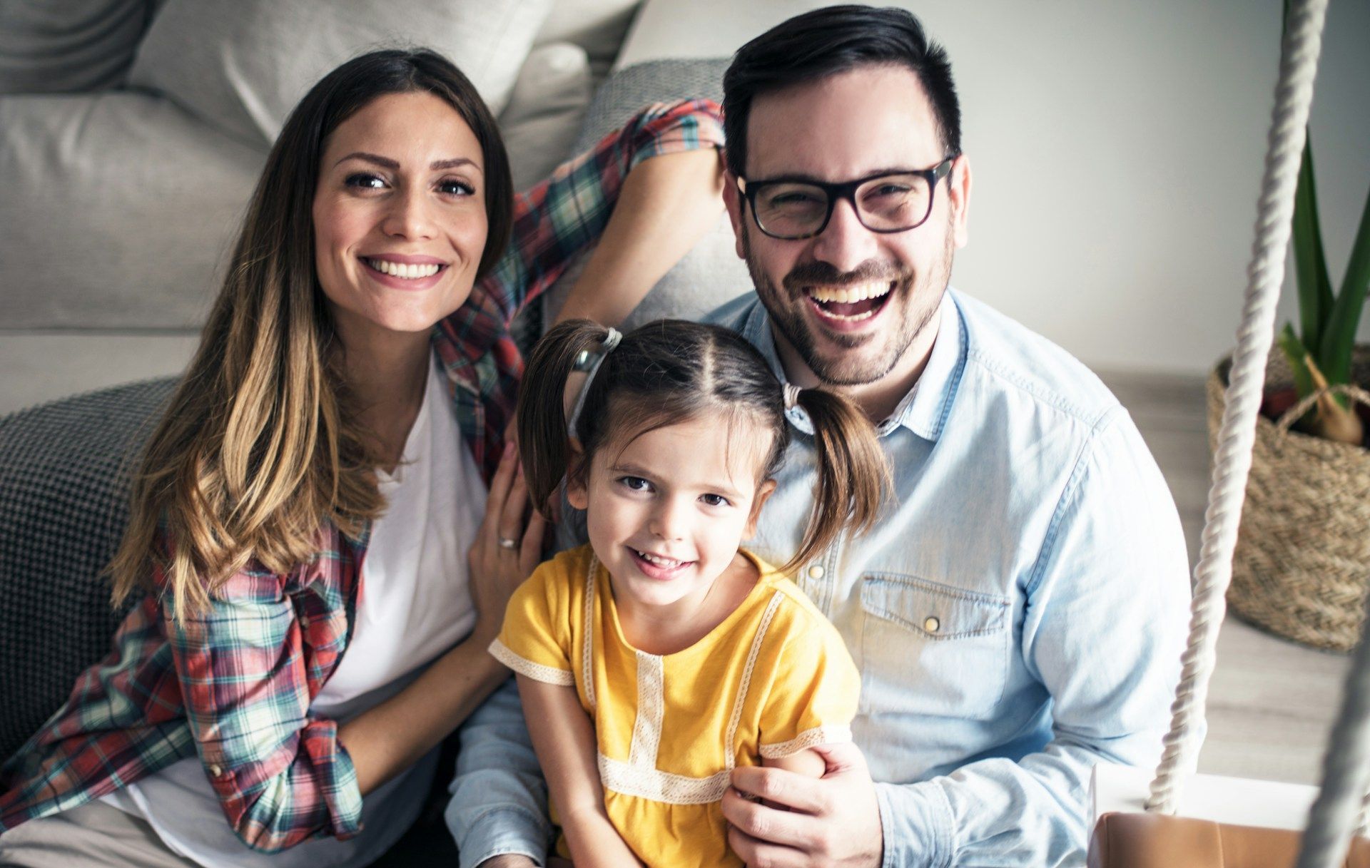 Man shows older man tablet while cooking in kitchen.
