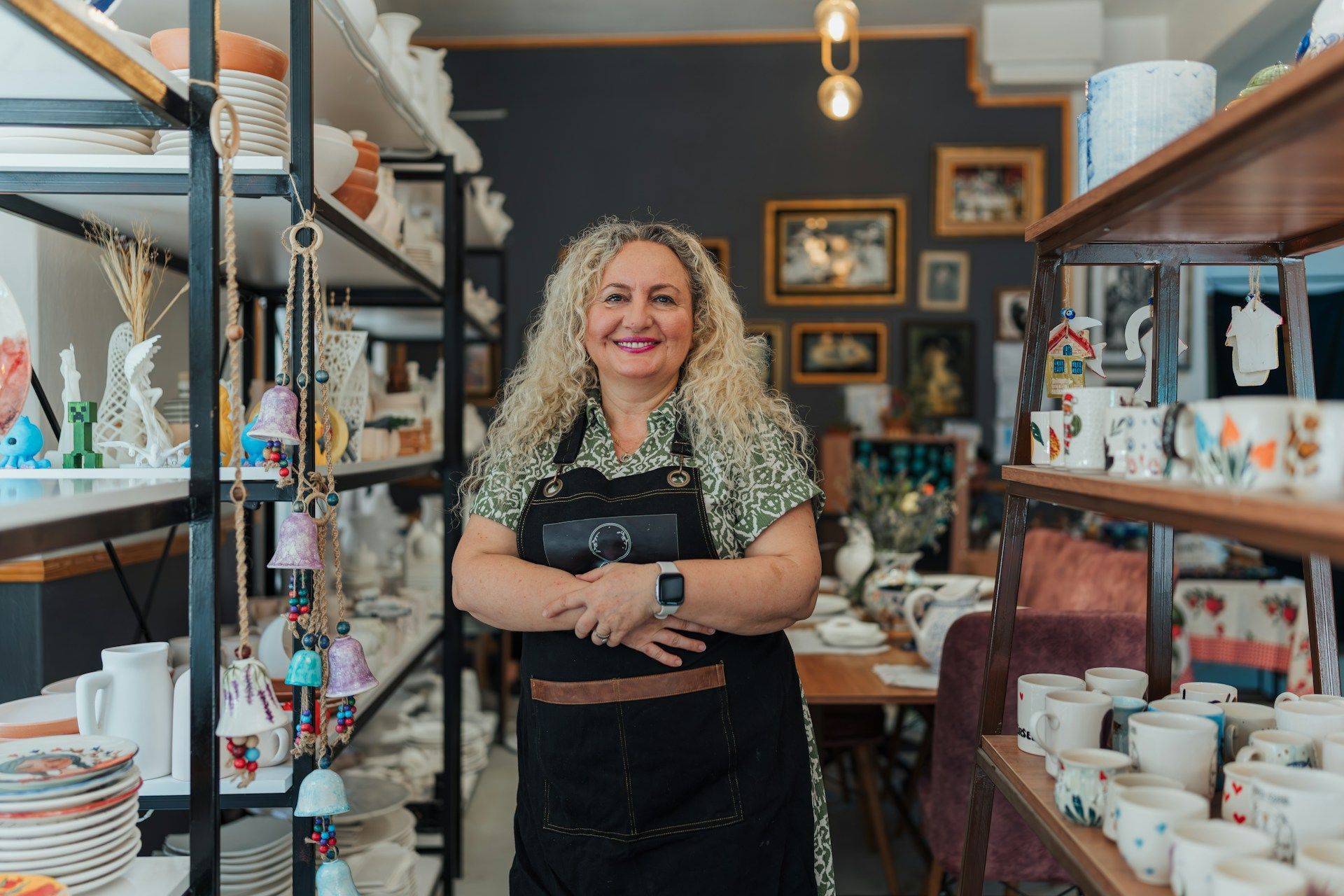 A barista taking an order from two customers at a cafe counter.