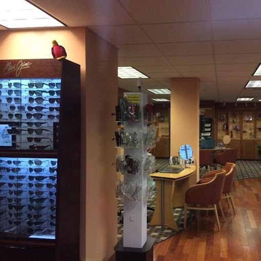 A woman is trying on glasses in an optical shop