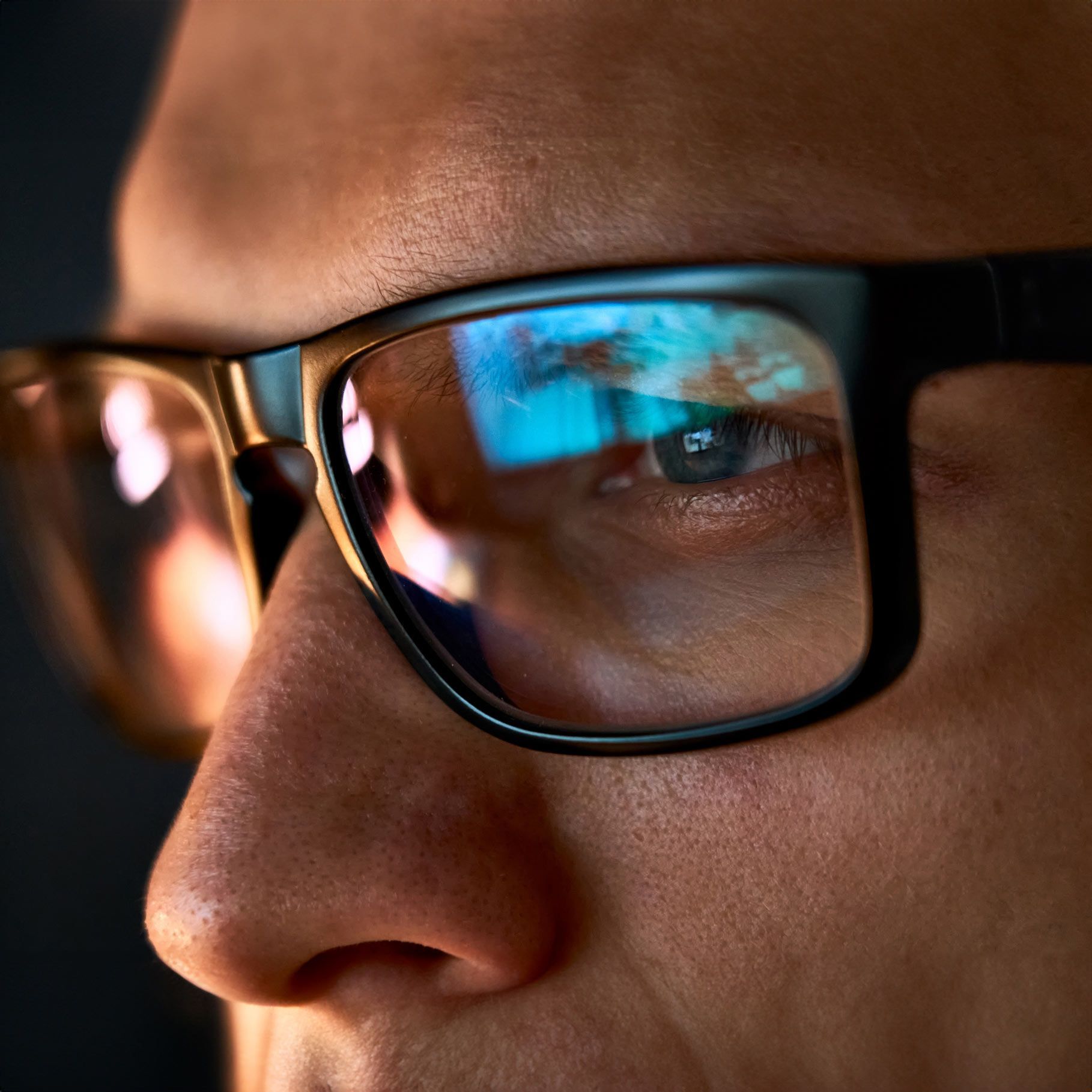 A close up of a man's face wearing glasses