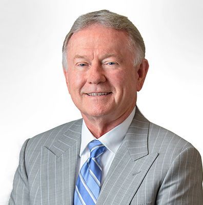 A man in a suit and tie is smiling for the camera.