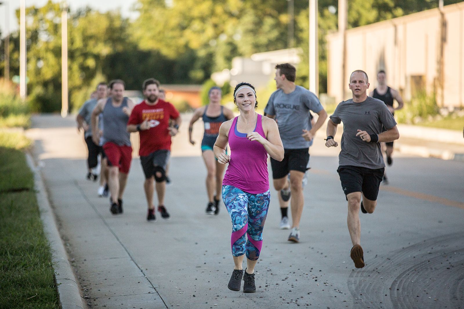 A group of people are running down a street.