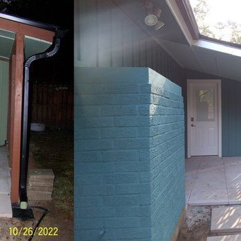 Exterior of a house with teal siding and a white door, contrasting with a black gutter.