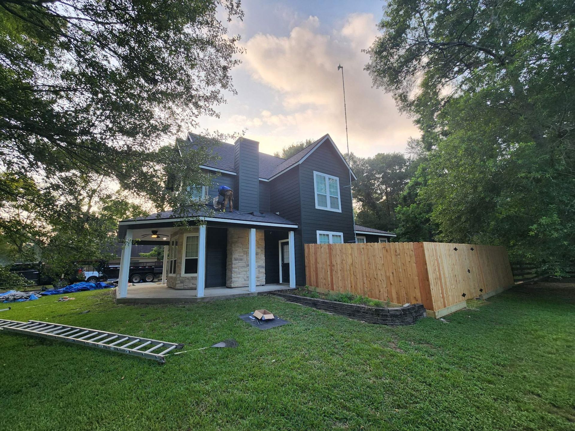 Solar panels on a white house roof against a blue sky.