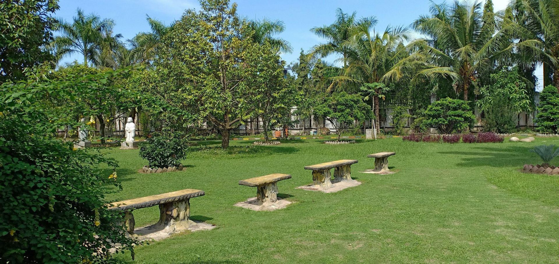 Person wearing yellow gloves uses a squeegee to clean a soapy bathroom mirror.