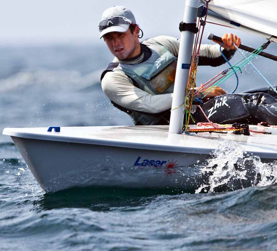 A man in a boat that says laser on it
