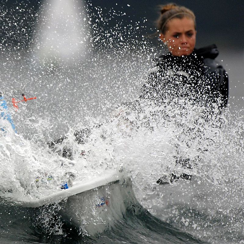 A woman is riding a wave on a surfboard