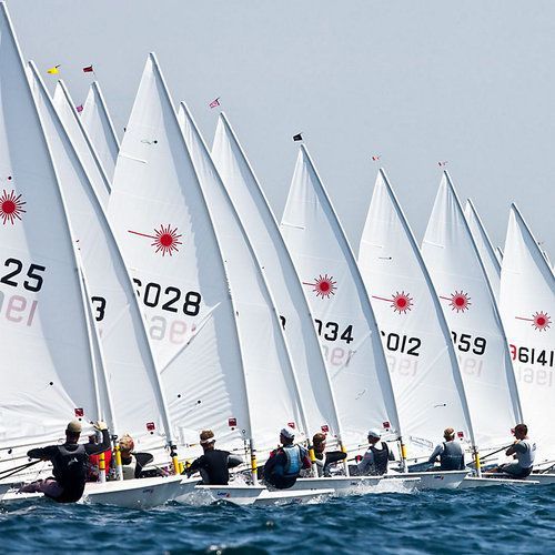 A row of sailboats with the number 25 on the sail