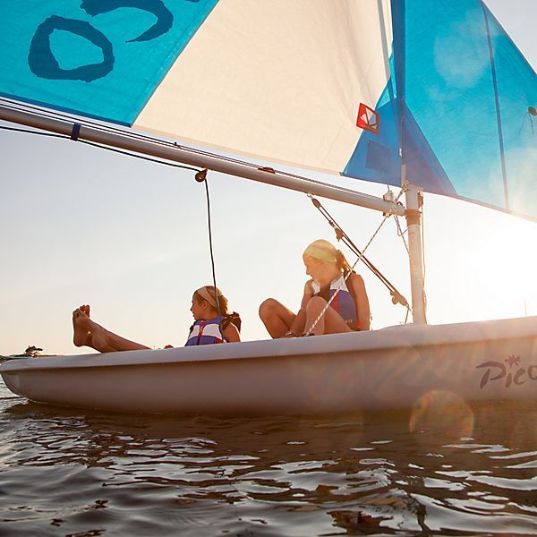 Two people in a sailboat that says pico on the side