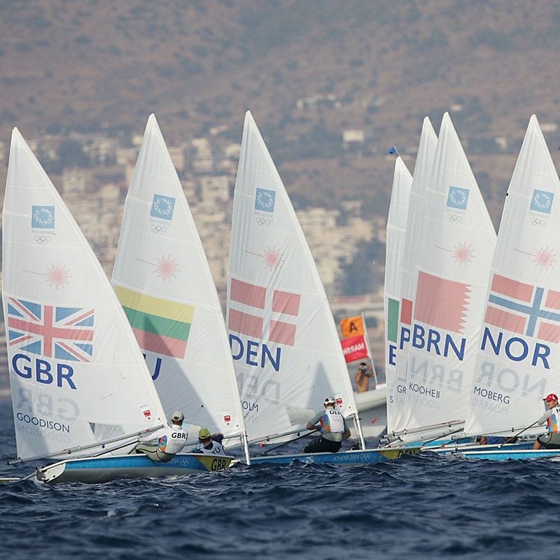 A group of sailboats with gbr on the sails