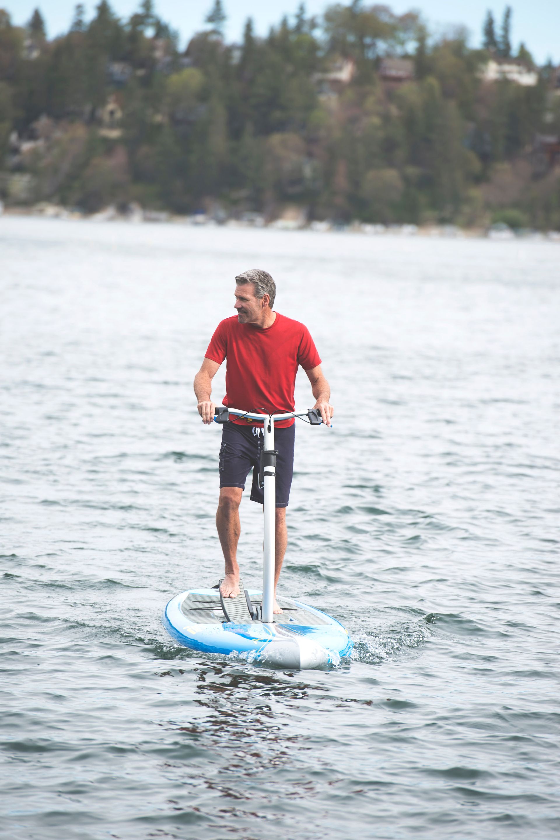 A man is riding a hydrofoil in the water.