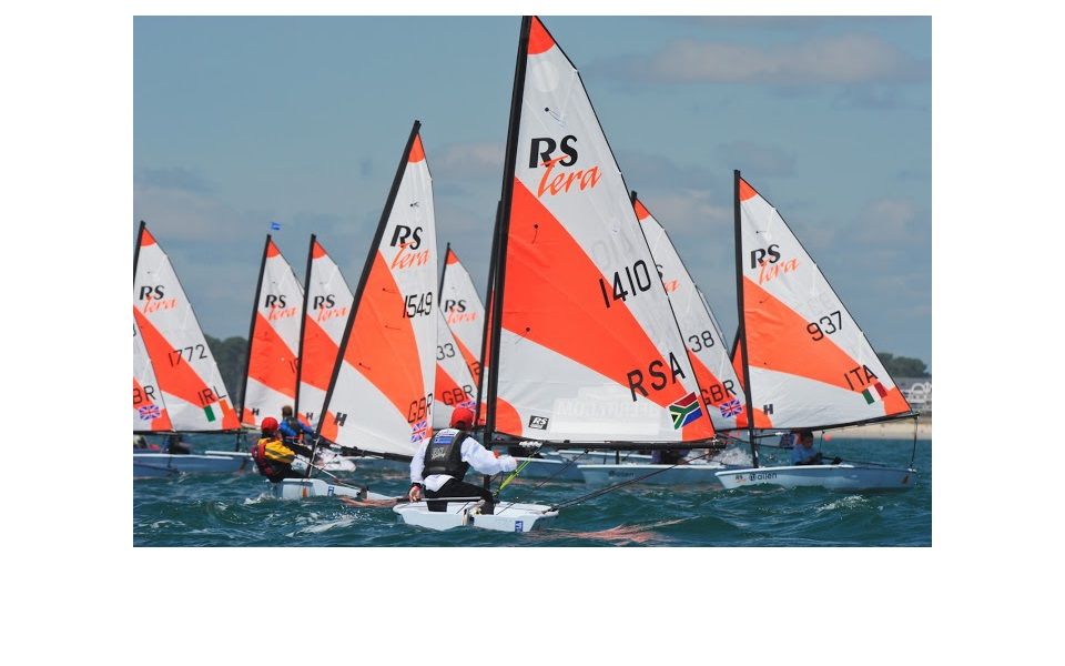 A group of people are sailing boats in the ocean.