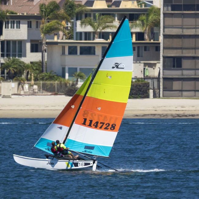 A sailboat with the number 114728 on the sail