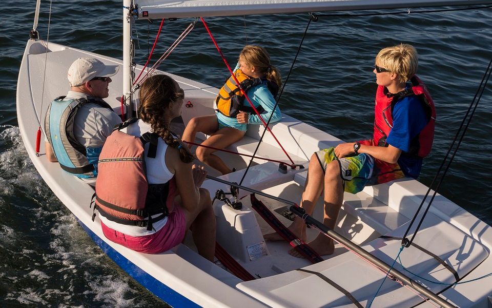 A group of people are sitting on a boat in the water.