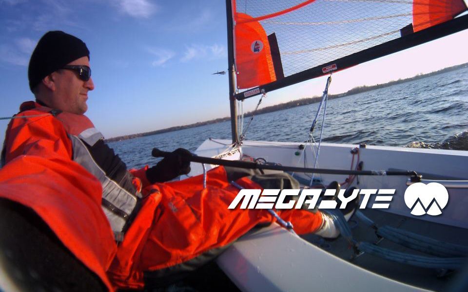 A man is sitting on a boat that says megabyte on it
