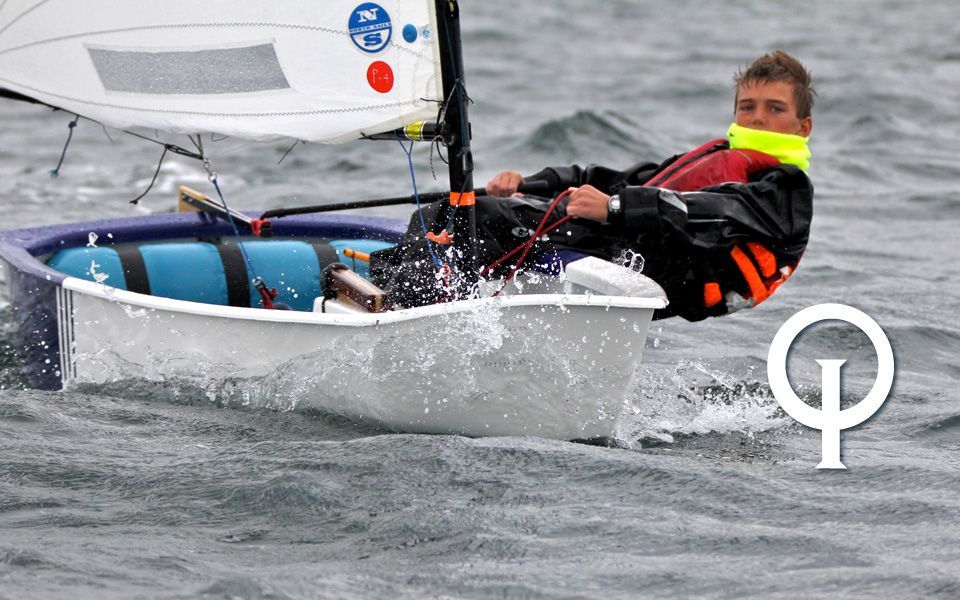 A man is sailing a small boat in the ocean