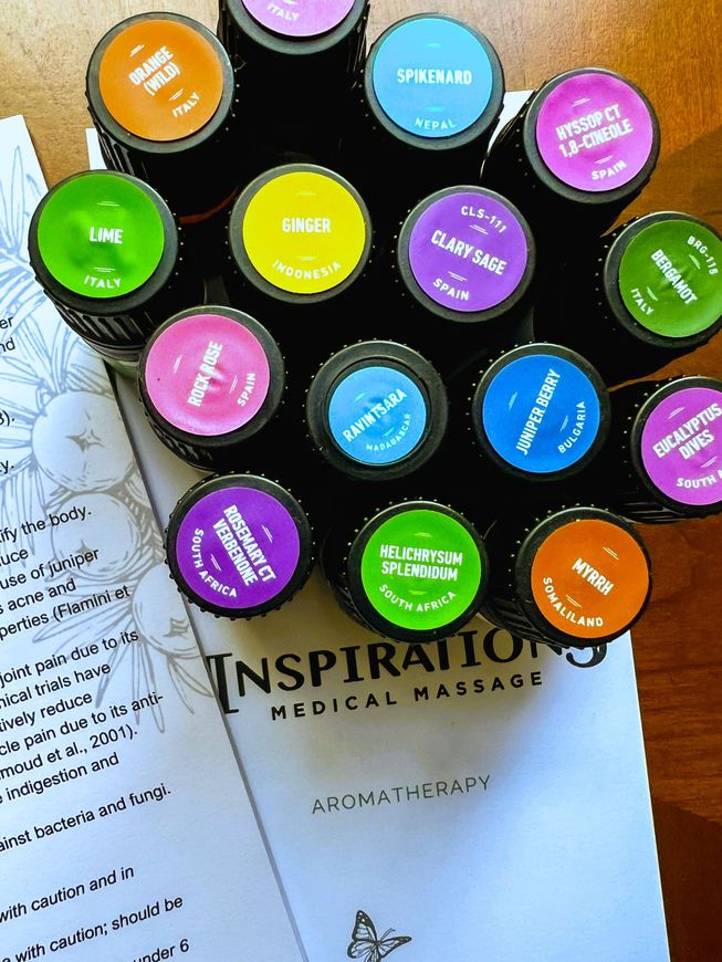 A bunch of bottles of essential oils are sitting on a table