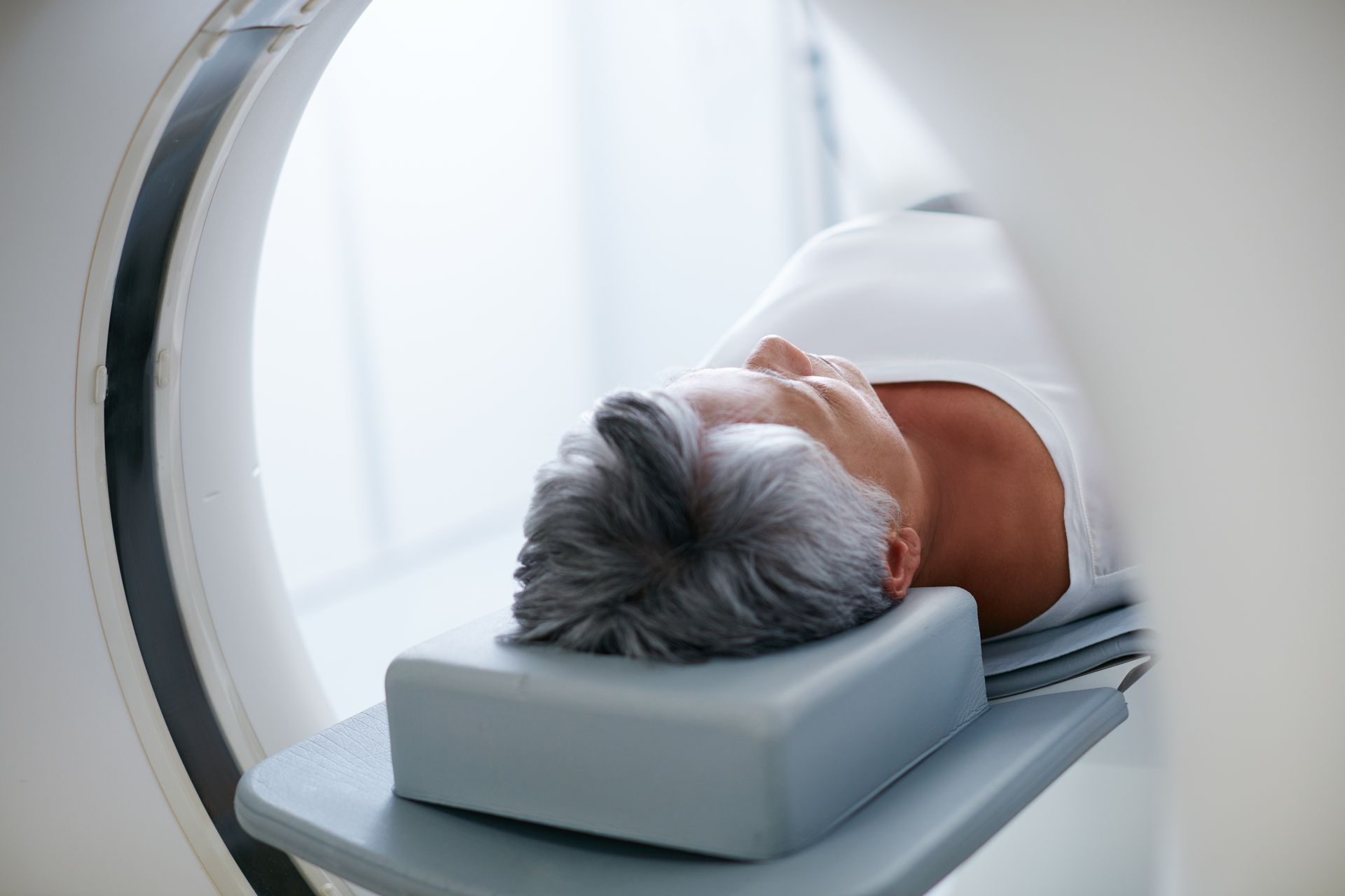 A woman is getting a ct scan of her head.