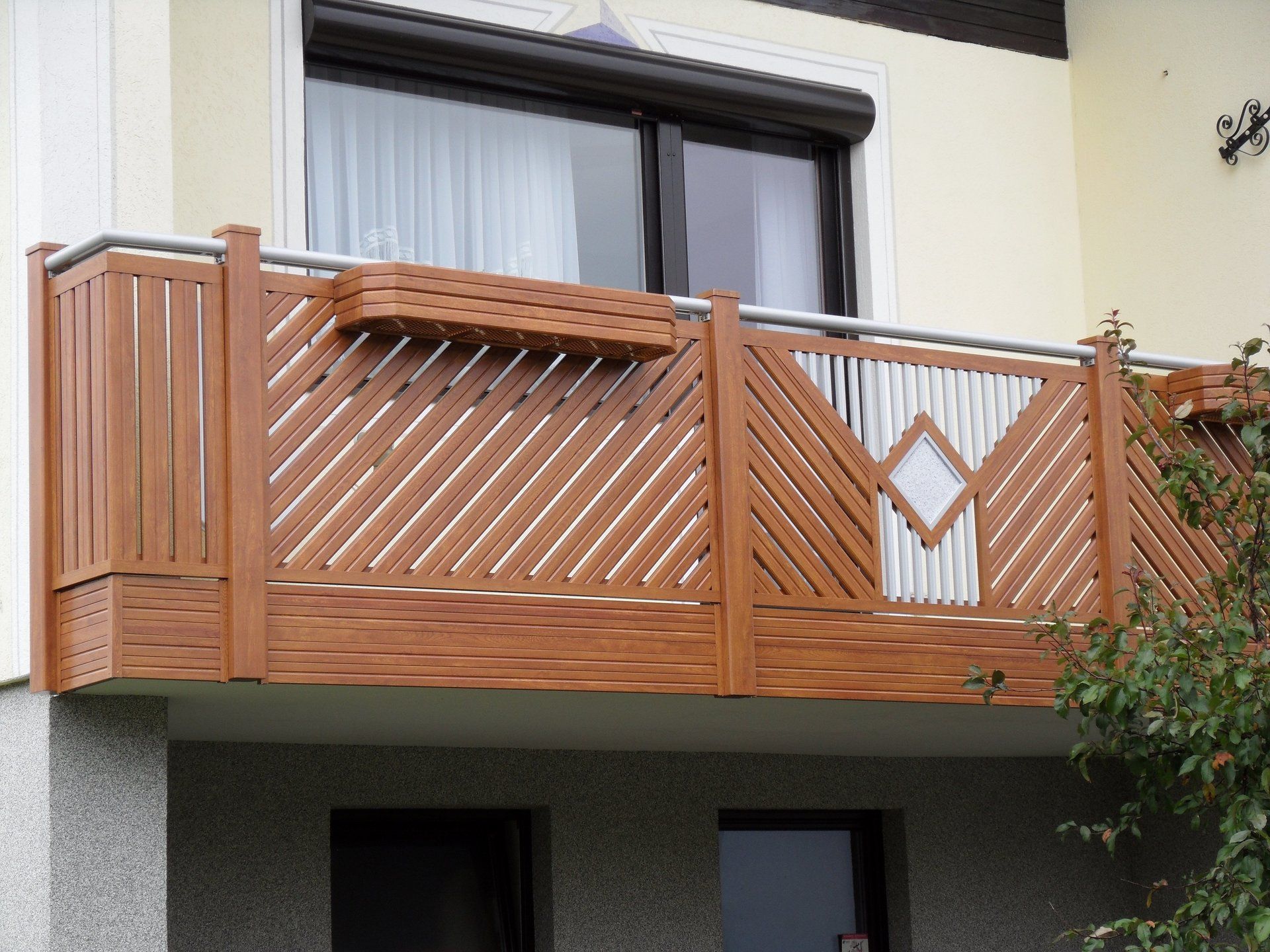 Ein Balkon an der Seite eines Hauses mit einem Holzgeländer