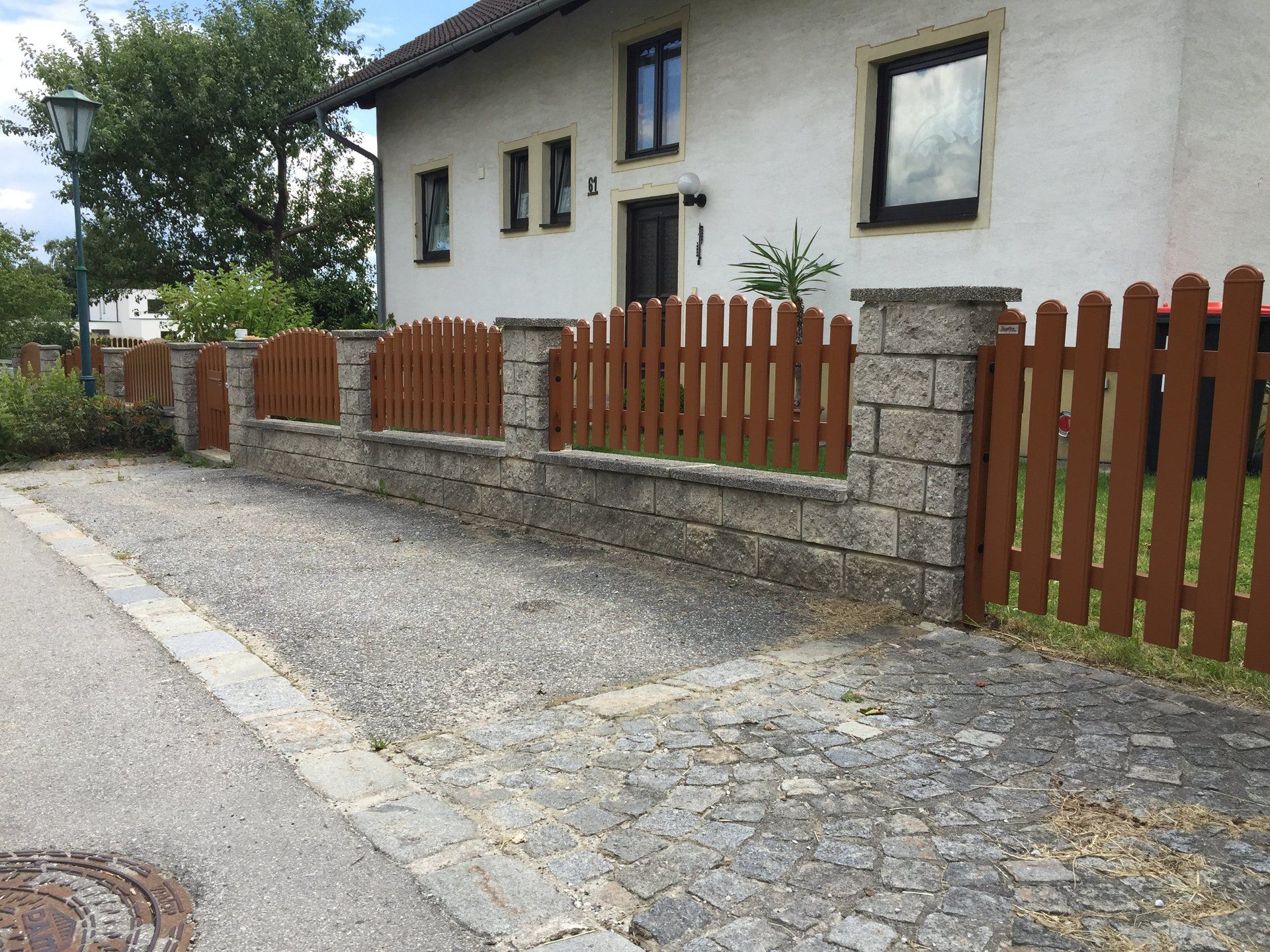 Ein Haus mit einem Holzzaun davor