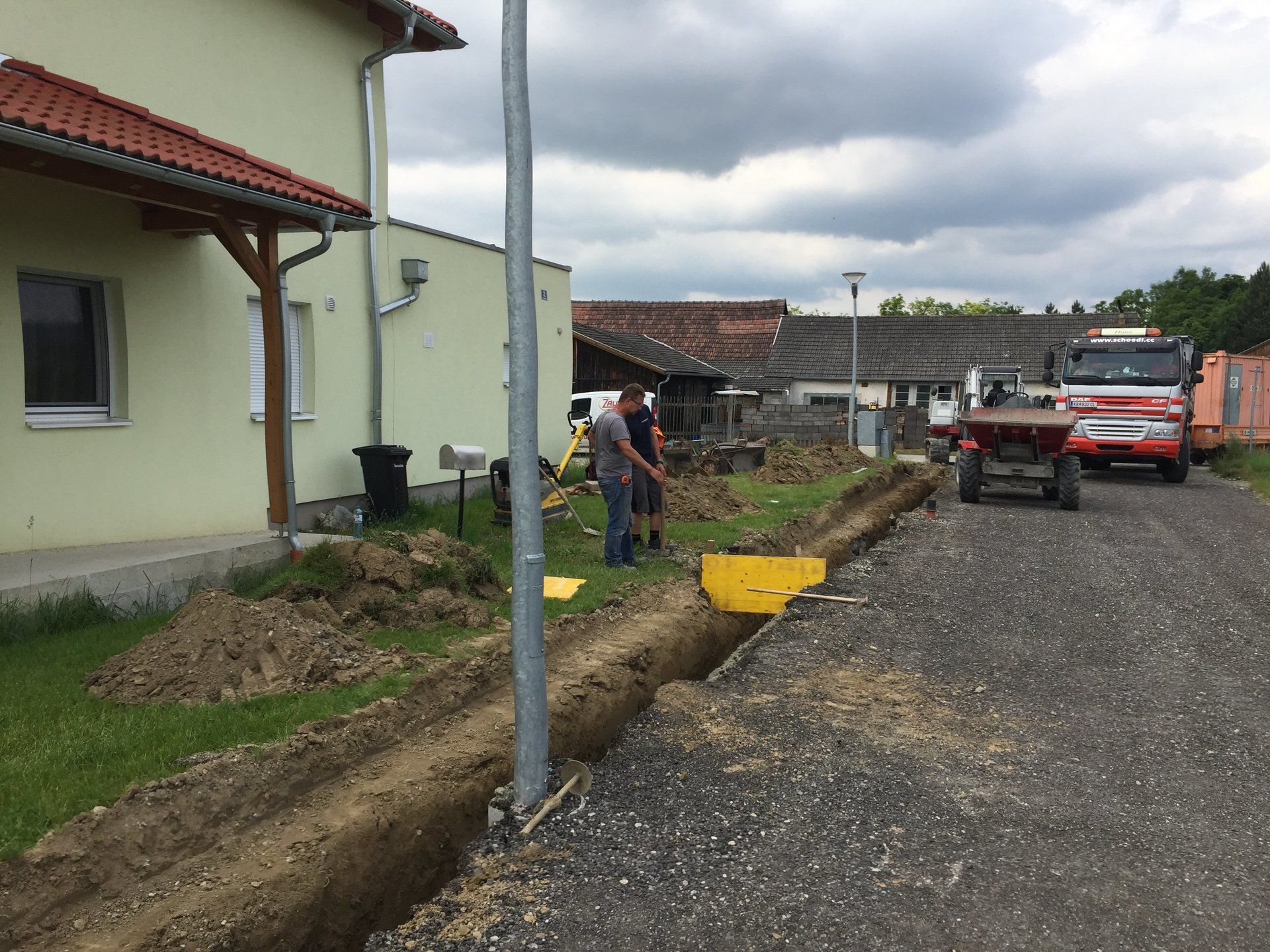 Ein LKW steht am Straßenrand vor einem Haus