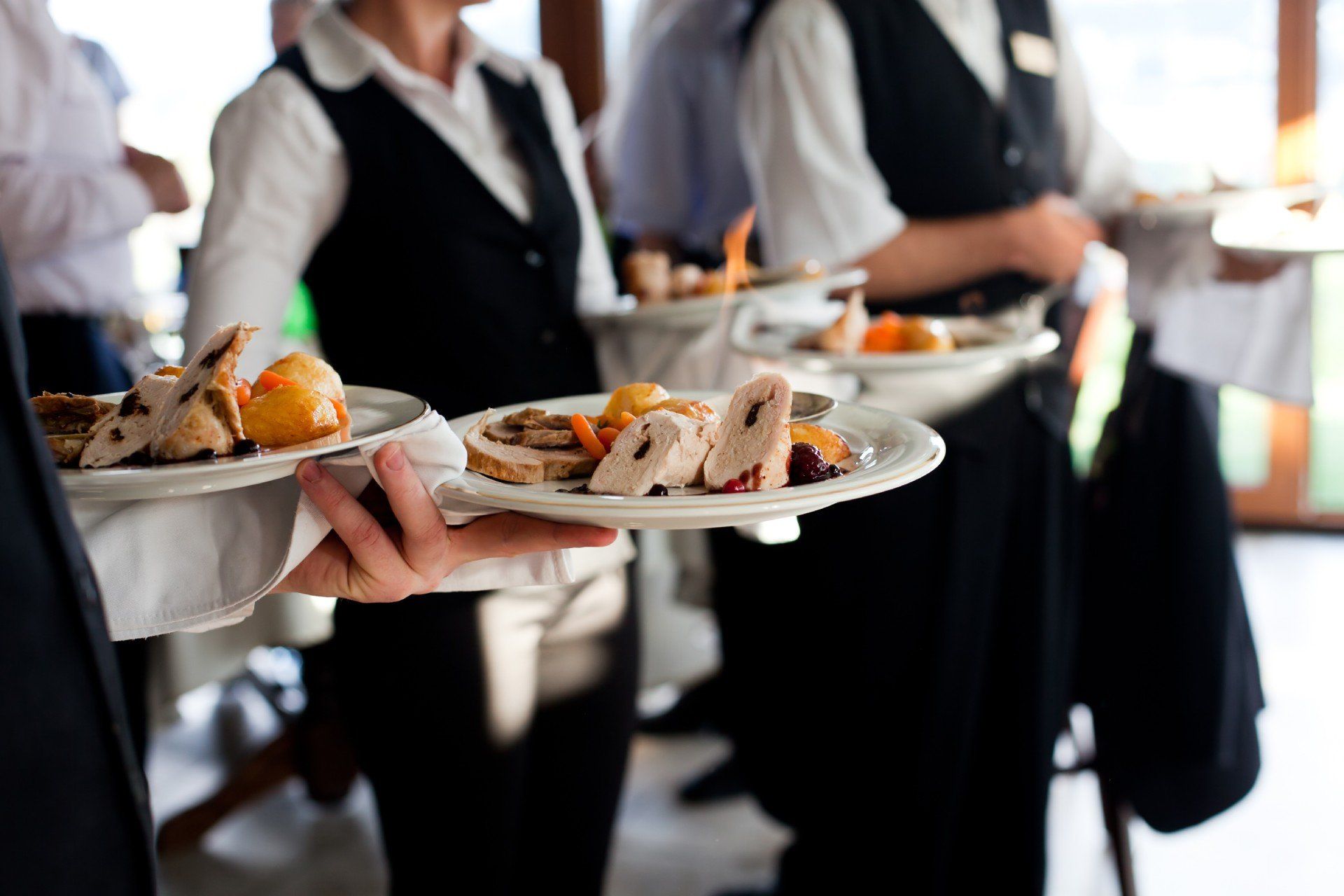 waiters holding food plates