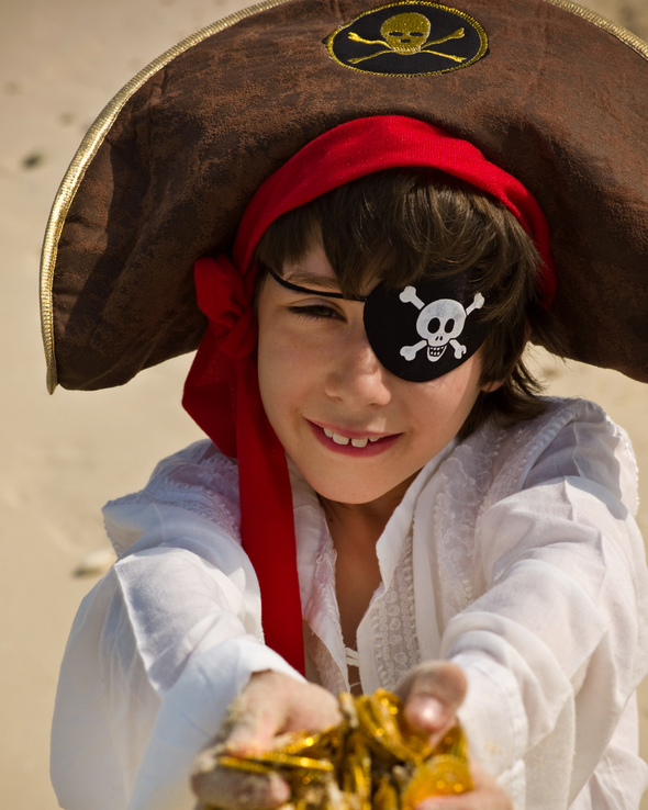 Young boy dressed as a pirate with an eye patch and tricorn hat