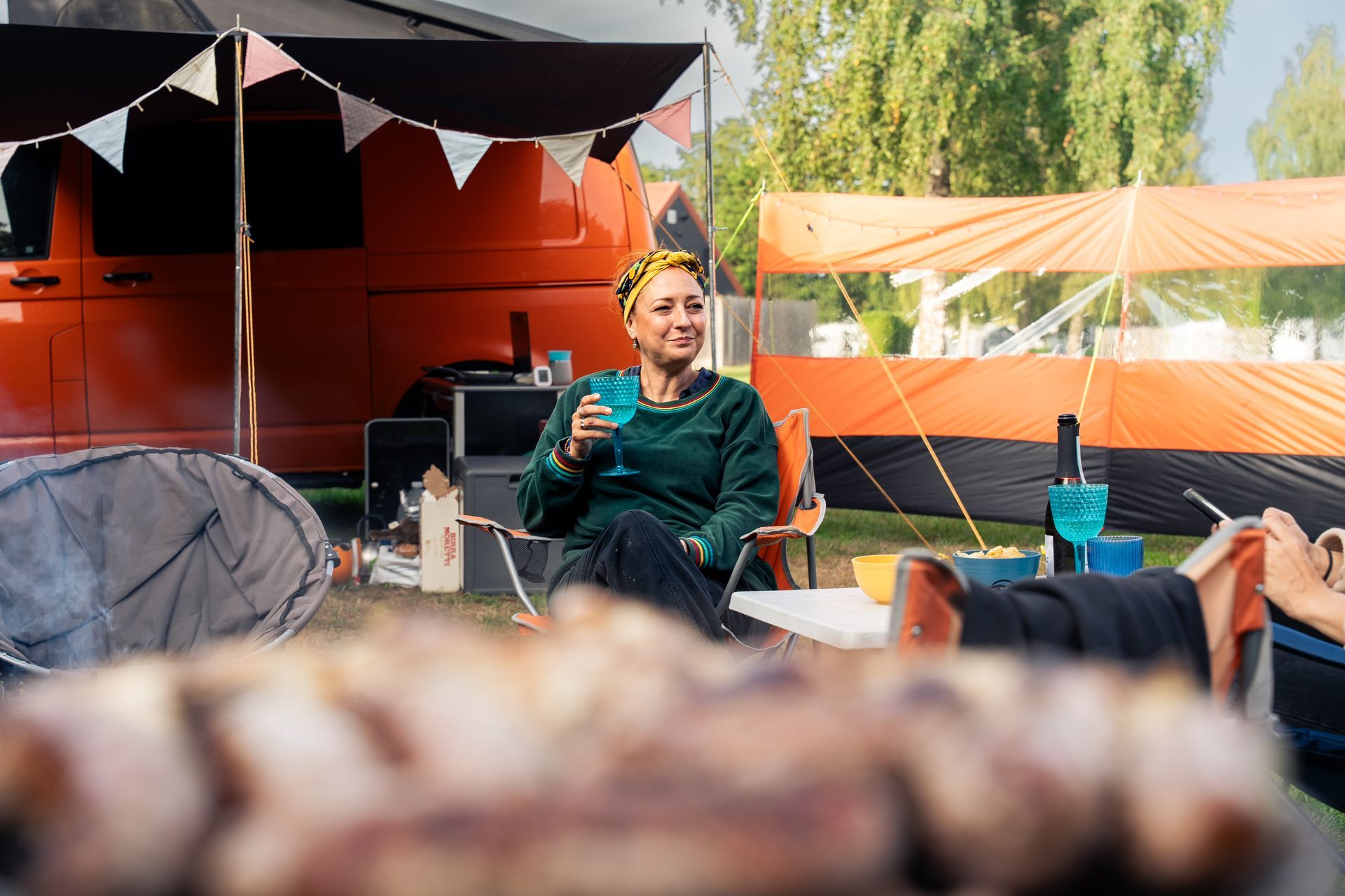Coyote in snow, facing forward with a downward gaze, brown fur and light brown eyes.