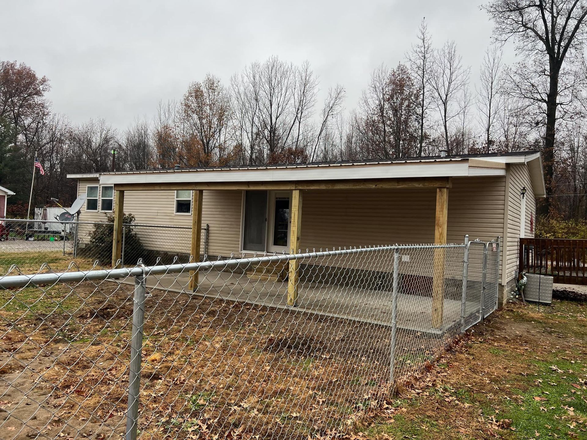 A Small House With A Fence Around It And A Porch - Princeton, IN - J. Koberstein Construction