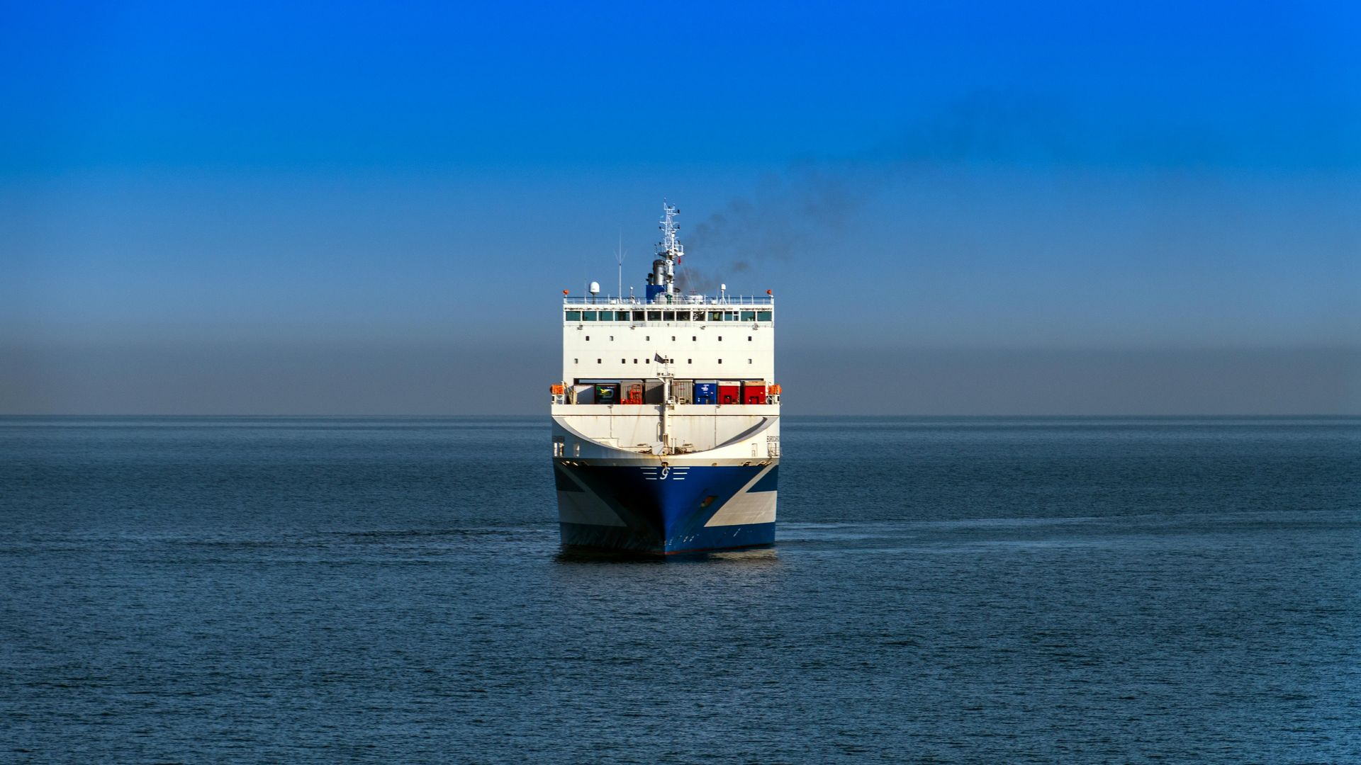 A large cruise ship is floating on top of a large body of water.