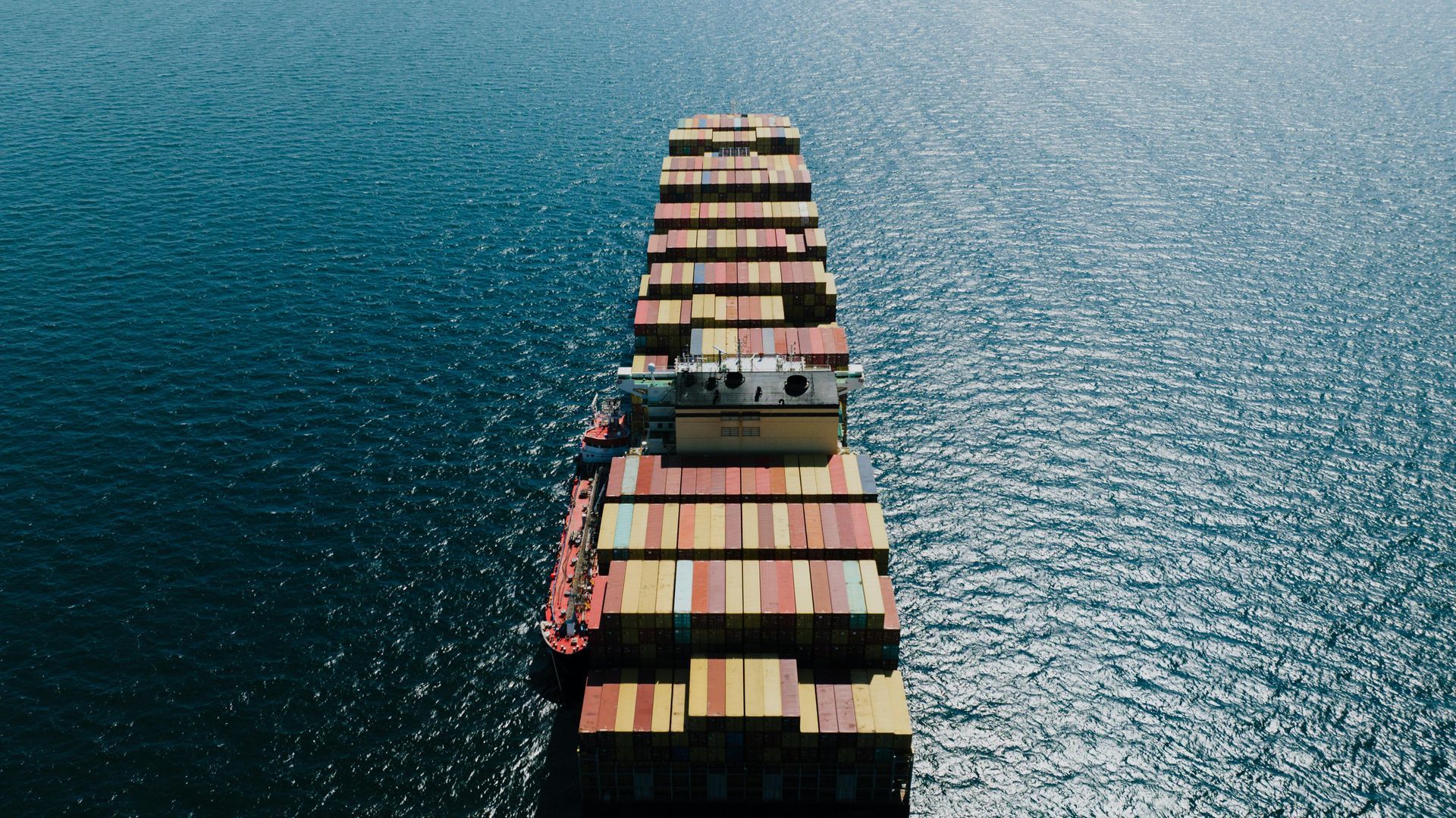 An aerial view of a large container ship floating on top of a body of water.