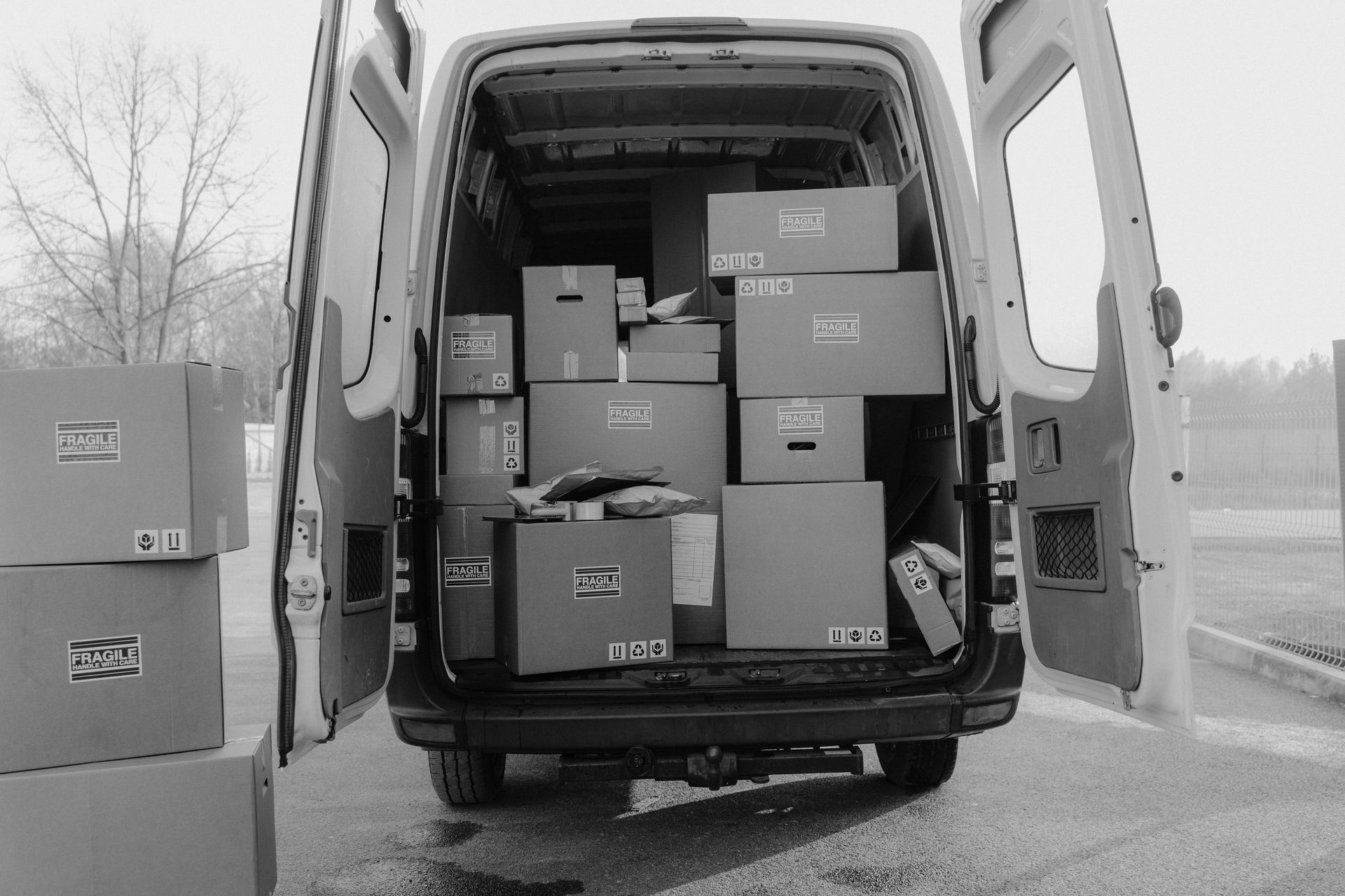 A black and white photo of a van filled with boxes
