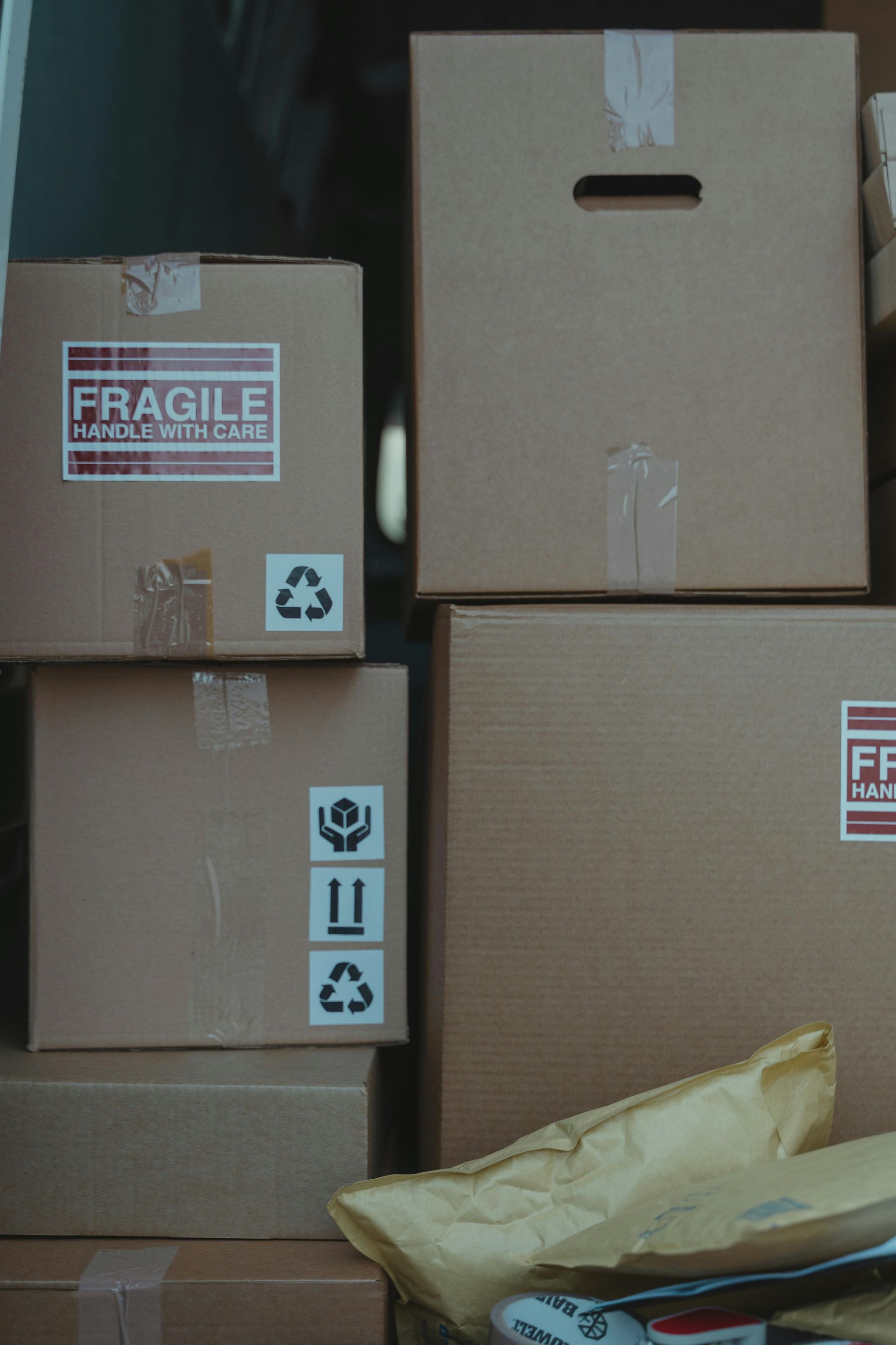 A bunch of cardboard boxes are stacked on top of each other.