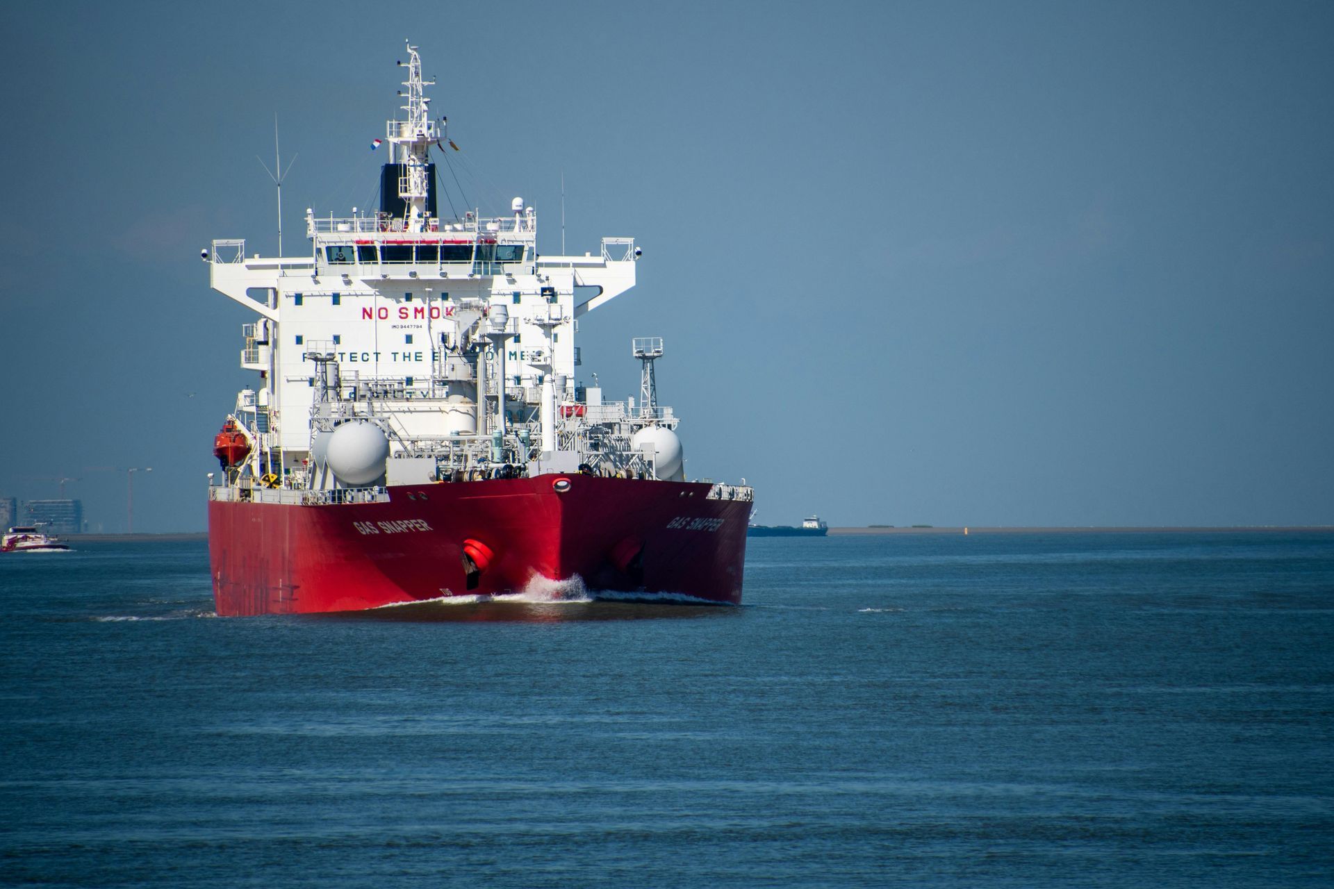 A large ship is floating on top of a body of water.