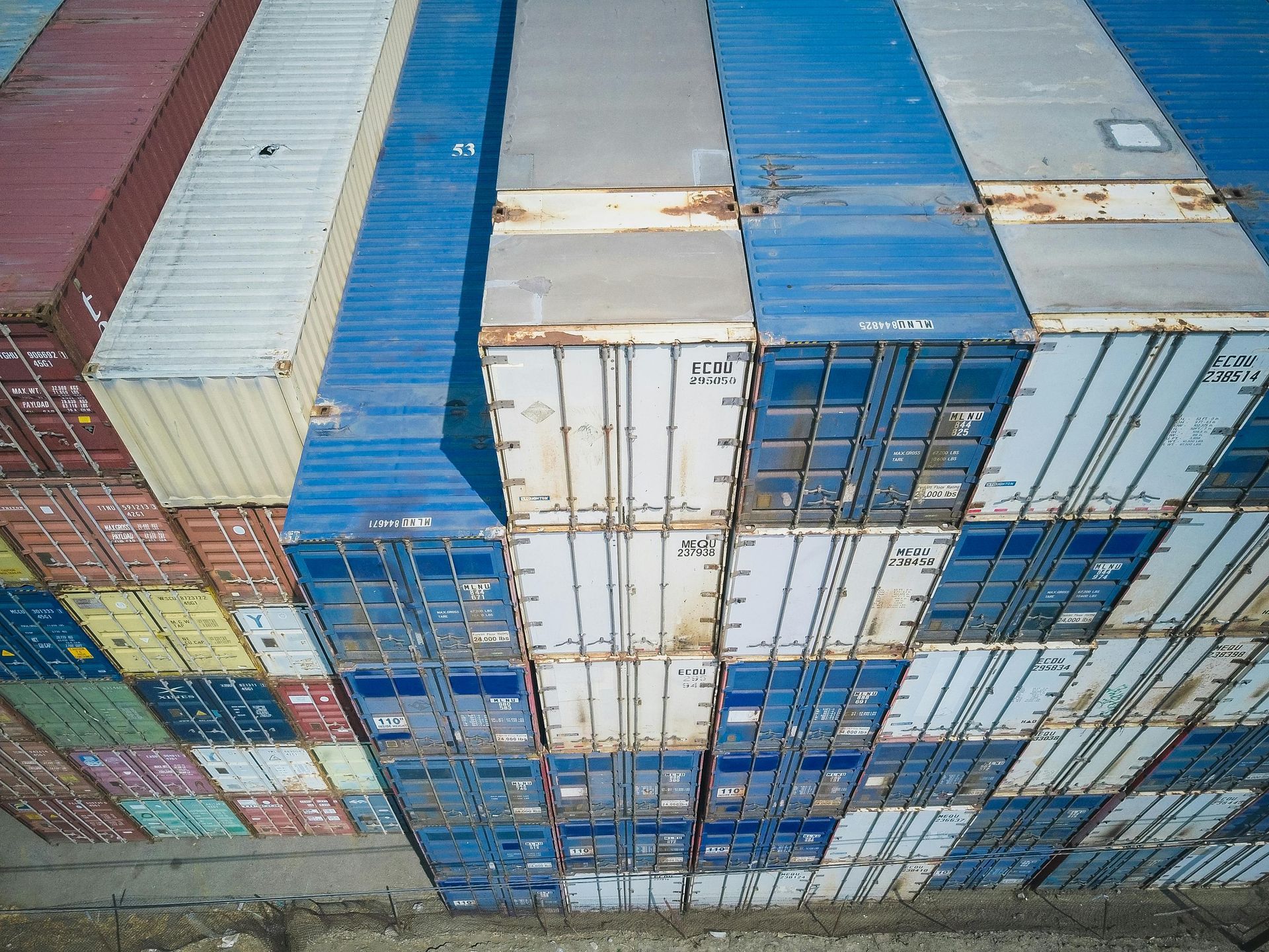 A bunch of shipping containers are stacked on top of each other.