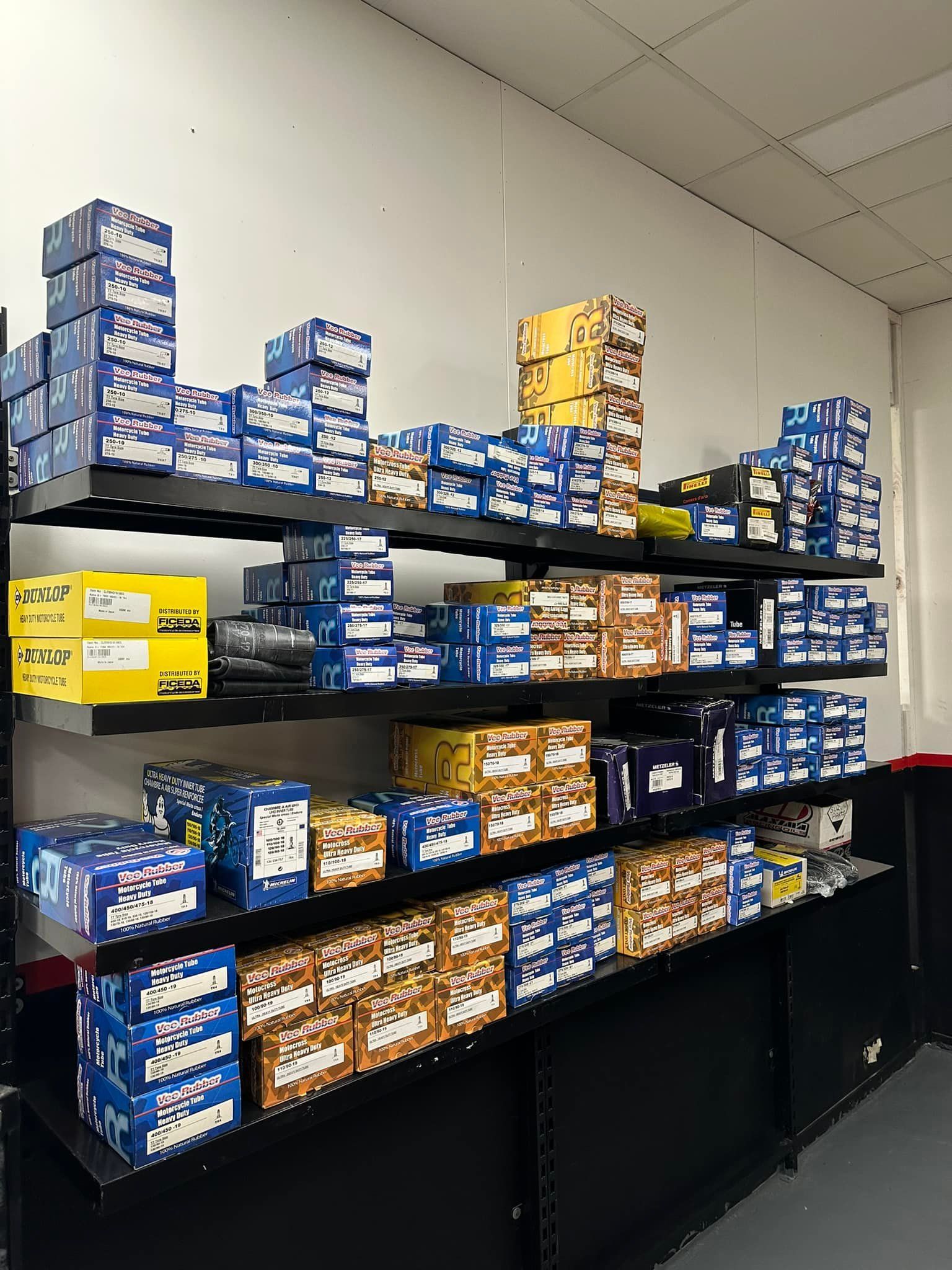 A shelf filled with lots of boxes of different types of parts — Newcastle Motorcycle Tyres in Broadmeadow, NSW