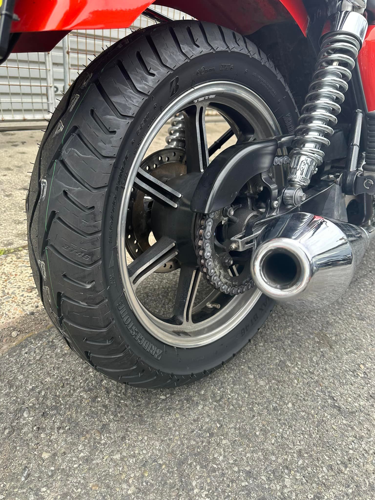 An extreme close-up of a motorcycle tyre while parked on a concrete road — Newcastle Motorcycle Tyres in Broadmeadow, NSW