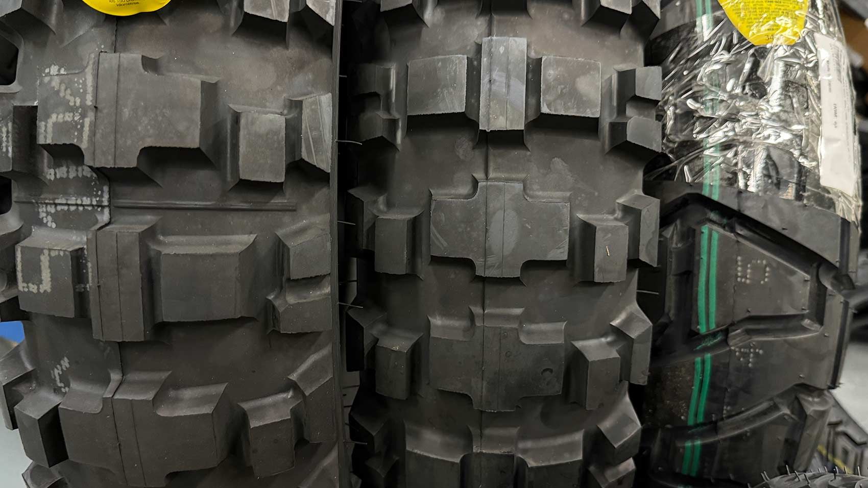 Close-up of Three Black Dirt Bike Tires With Chunky Tread Patterns — Newcastle Motorcycle Tyres in Broadmeadow, NSW