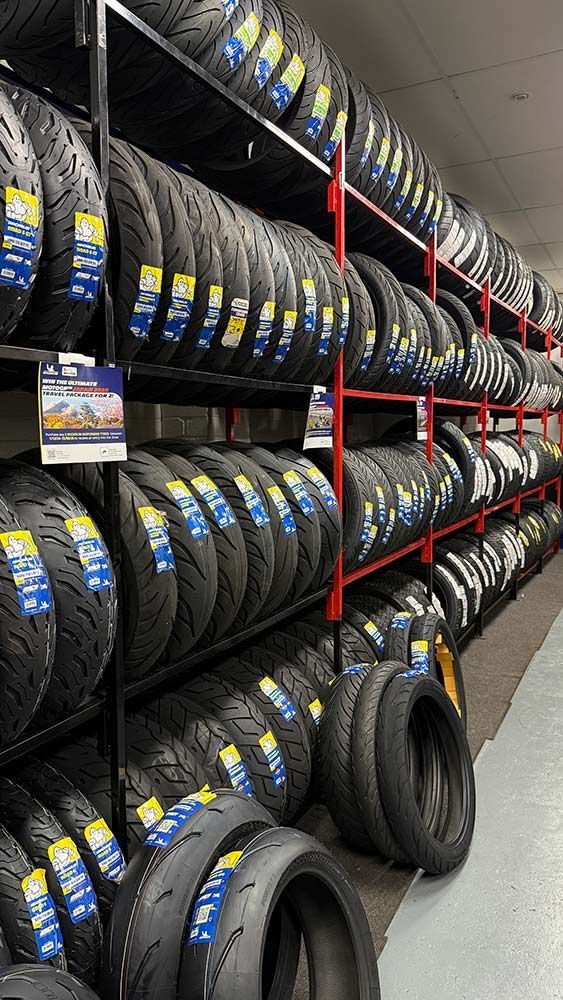 Shelves Stacked With Numerous New Tires in a Store — Newcastle Motorcycle Tyres in Broadmeadow, NSW