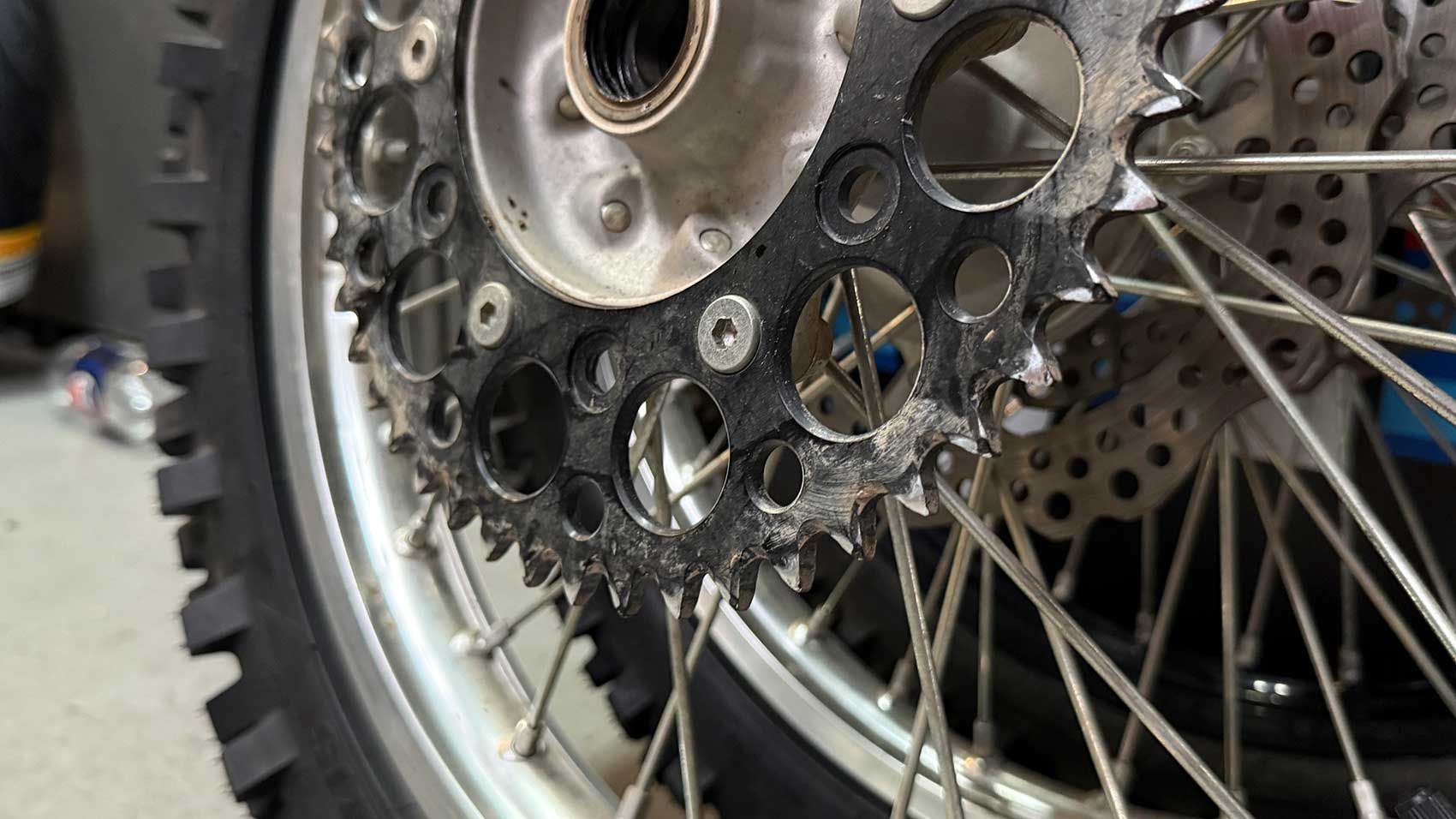Close-up of a Motorcycle's Rear Wheel, Sprocket With Wear and Tear — Newcastle Motorcycle Tyres in Broadmeadow, NSW