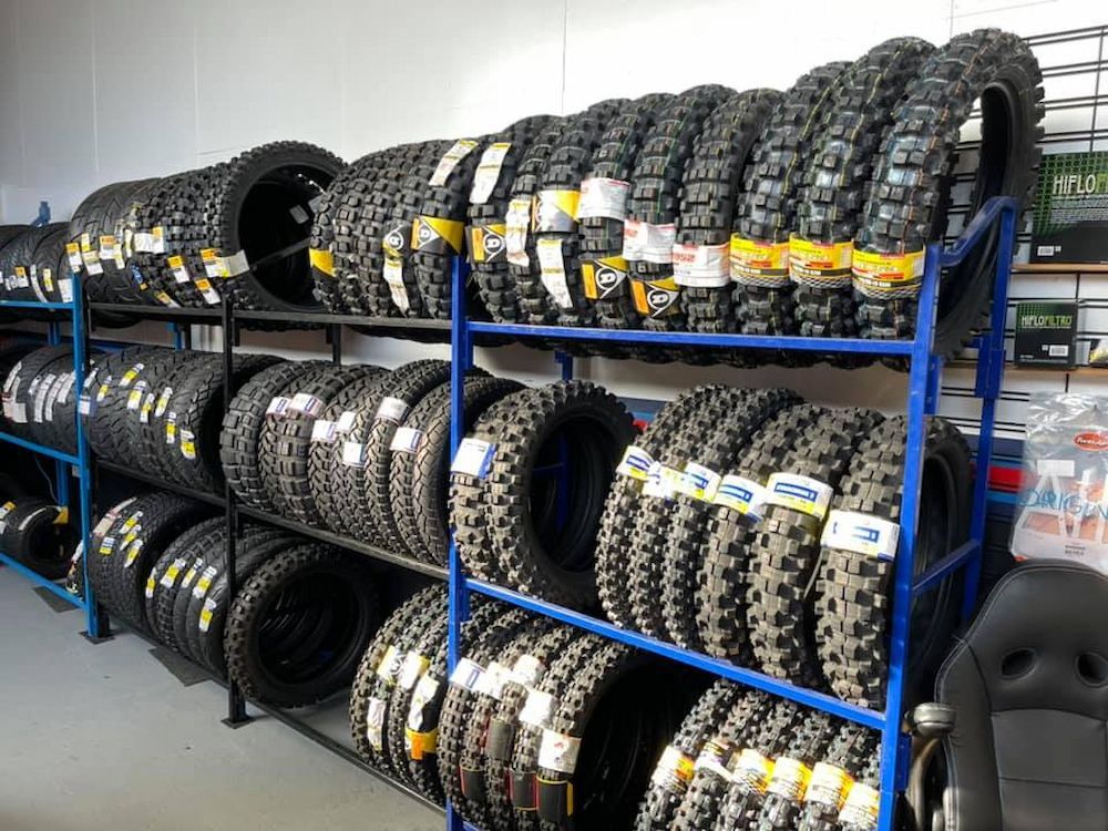 A Bunch of Tyres Are Stacked on Shelves in a Store — Newcastle Motorcycle Tyres in Broadmeadow, NSW