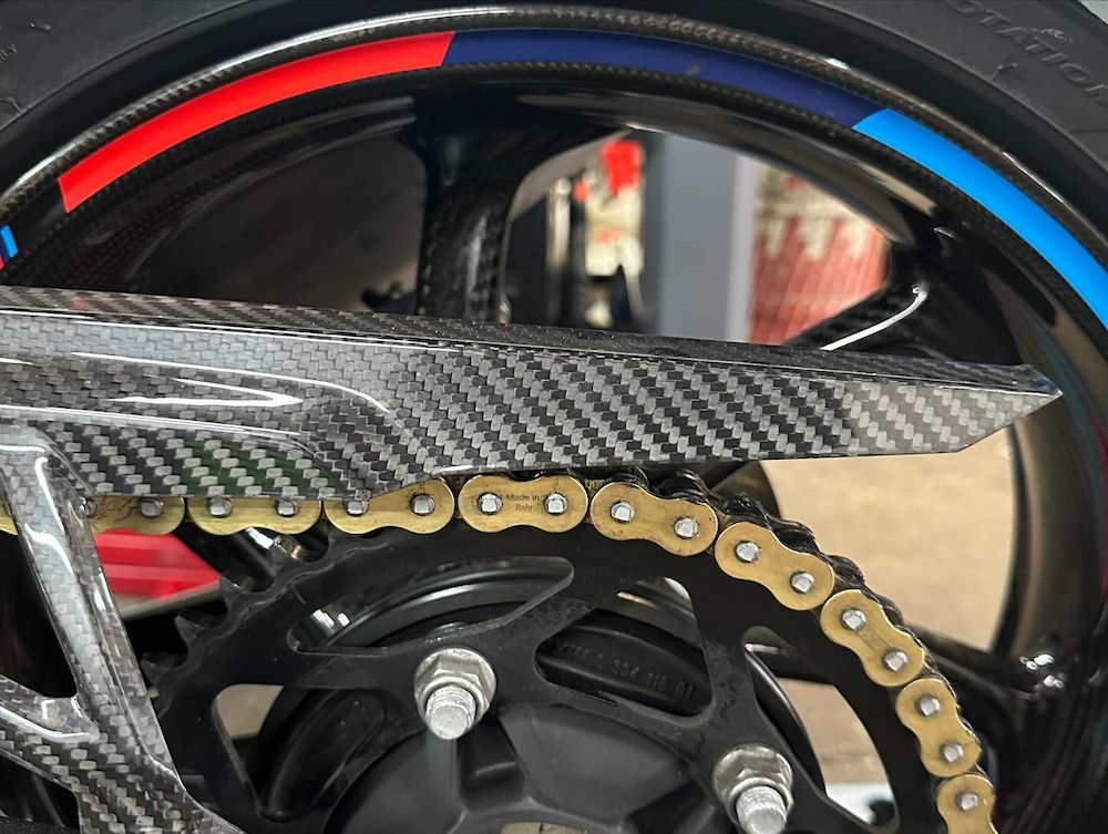 A Close Up of a Motorcycle Wheel With a Chain on It — Newcastle Motorcycle Tyres in Broadmeadow, NSW