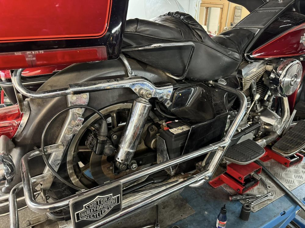 A Harley Davidson Motorcycle is on a Lift in a Garage — Newcastle Motorcycle Tyres in Broadmeadow, NSW