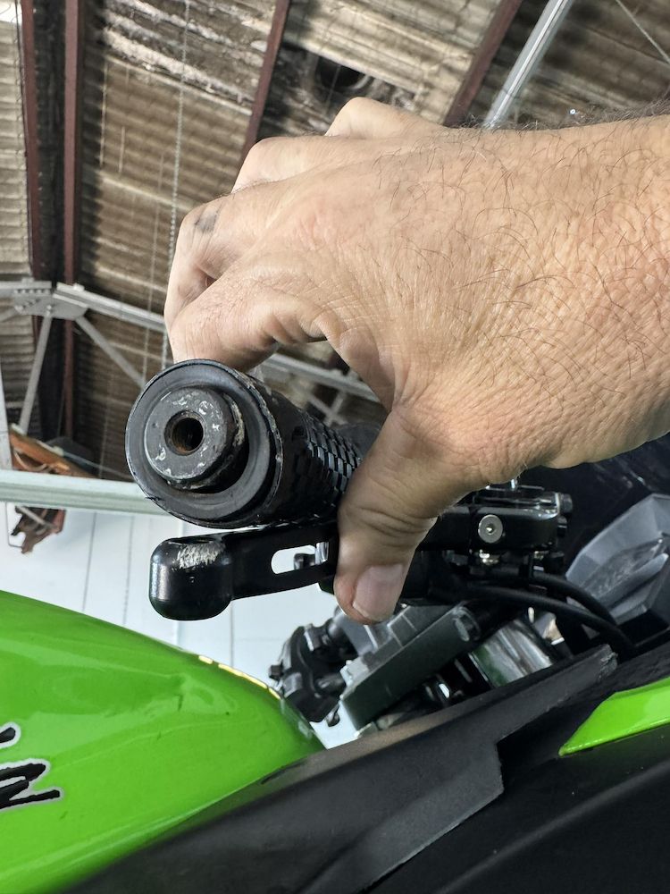 A Person is Holding a Handlebar and Break on a Motorcycle — Newcastle Motorcycle Tyres in Broadmeadow, NSW