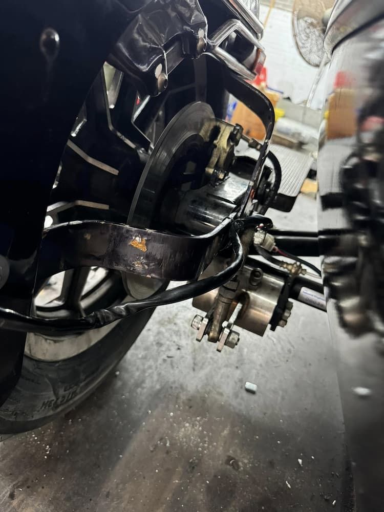A Motorcycle is Sitting on the Ground in a Garage — Newcastle Motorcycle Tyres in Broadmeadow, NSW