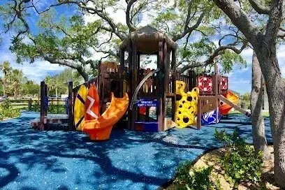 Hvac-Contractor-Bradenton-A colorful playground in a park with trees in the background.