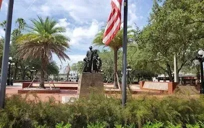 Hvac-Contractor-Bradenton-Statue of people in a park, with US flag and palm trees.
